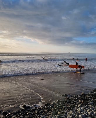 An evening surf lesson at Ynyslas, with big clean waves and lots of surfers enjoyig the sea. 