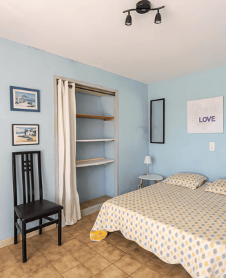 a bedroom with a bed and a chair