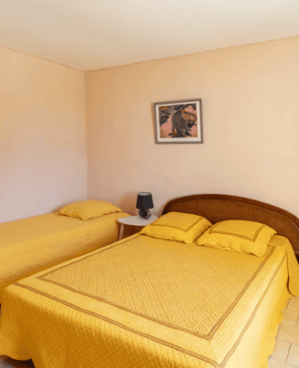 a bedroom with two beds and a door way to the bathroom