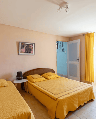 a bedroom with two beds and a table