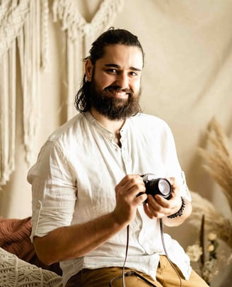 Thomas, fine art elopement photographer in Provence, smiling with camera in hand