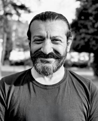 Mehmet Başkak, Tai Ji and Wudang Sword instructor of WDP Turkey, smiling outdoors in black shirt.