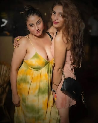 two women standing next to each other in a room