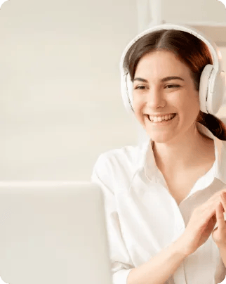 Woman using a laptop wearing headphones