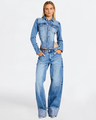 a woman in a denim jacket and jeans jeans