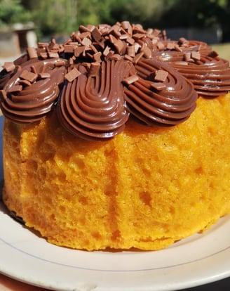 a cake with chocolate frosting on top of a white plate