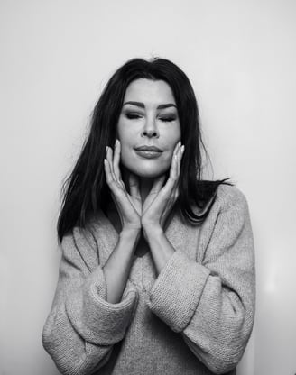 a woman with long hair and a sweater on