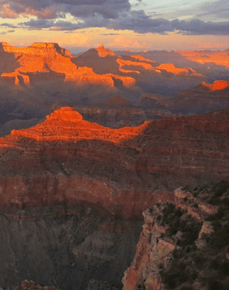 Tourist at Grand Canyon North Rim at Sunset