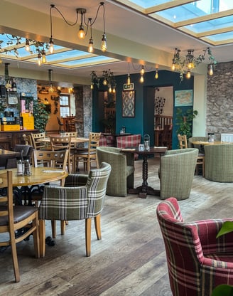 A restaurant with a skylight and tables and chairs