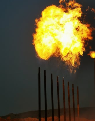 a large explosion of yellow flames in a field