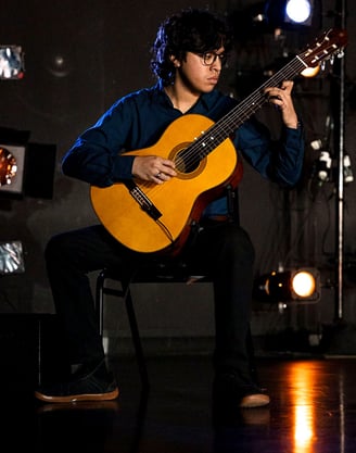 Chris Galindo playing a classical guitar