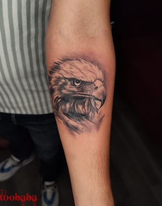 A client smiling and showing off their newly completed tattoo from Tattoo Baba.