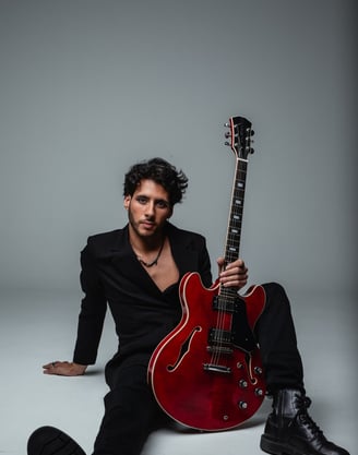 a guitar player in a suit and a guitar