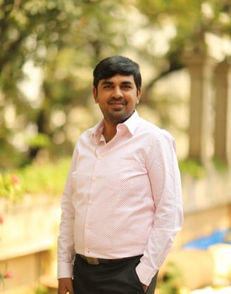 a man in a pink shirt and black pants