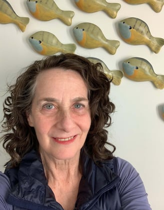 Jane Freidson with ceramic fish on the wall