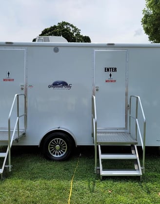 2 stall portable restroom trailer at a local outdoor event