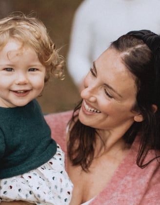 a woman holding a baby in her arms