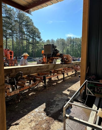 The Custom Sawyer sawmilling a 38 foot sinker cypress log with Woodmizer LT70 sawmill, in Rentz, GA