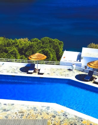 a pool with umbrellas and umbrellas on a sunny day