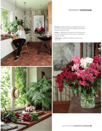 a woman sitting at a table with flowers in a vase, in French countryside, in a normandy cottage,