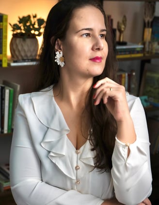 a woman in a white shirt and earrings