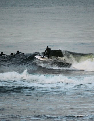 A surfer doing a top turn on a clean shoulder high wave