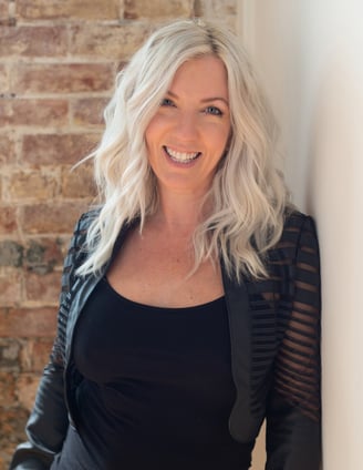 Headshot of artist and photographer Tanya Smith of Sweet Ruby Moon on brick wall