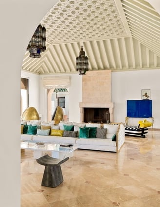 Living room at Villa El Rincon in Marbella featuring sea views, elegant décor, fire place and floor-to-ceiling windows.