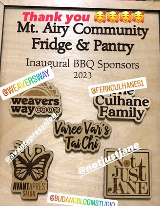 A wooden plaque with names/logos of organizations related to our first bbq.
