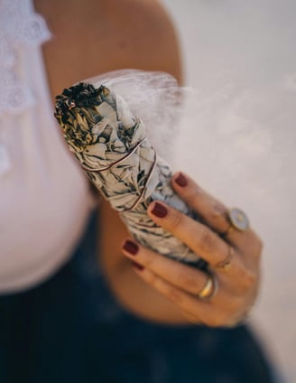 herbal smudge and a hand
