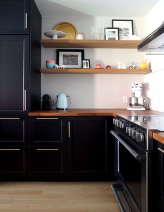 a kitchen with a stove and wood countertop