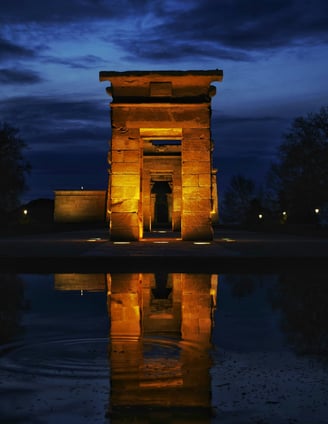 debot temple is a large stone structure with a dark sky in the background