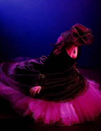 a woman in a black dress and fancy hat dancing around