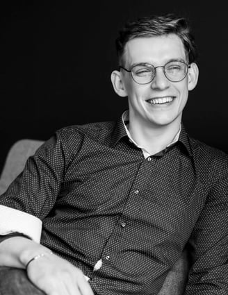 a man sitting on a couch with a cup of coffee