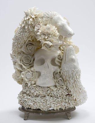 sculptur a skull head with a skull and flowers on it