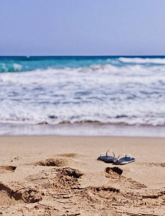 a pair of flip flop on the beach