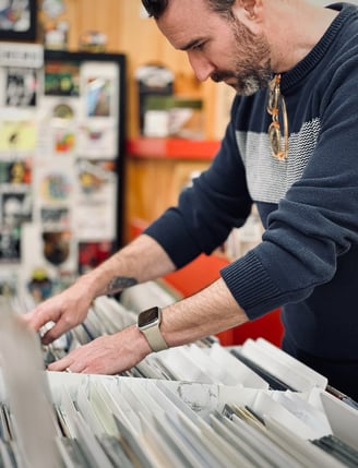 A man looking through vinyl records in a shop