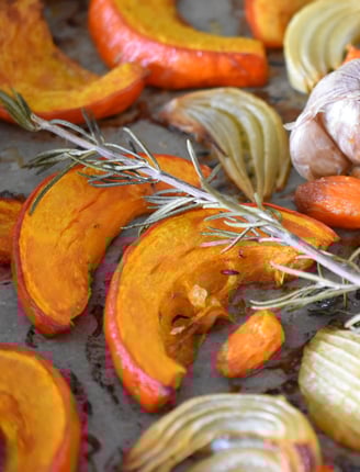 roasted pumpkin and herbs on a tray