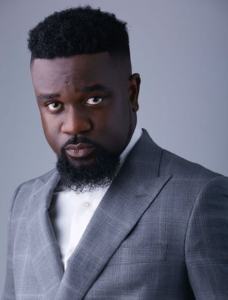 Sarkodie in a silky ash suit.