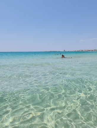 Torre San Giovanni Beach, Puglia – A long stretch of golden sand with calm, shallow waters, perfect 