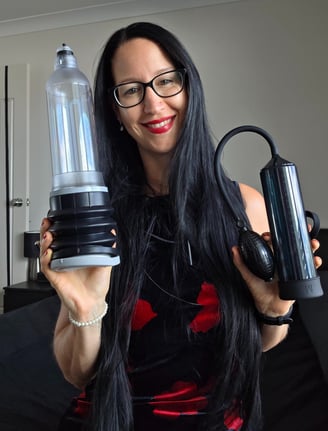 Pleasurelit Patricia holding two different penis pumps for tips
