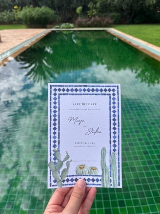 moroccan wedding invitation with a tile green pool in the background