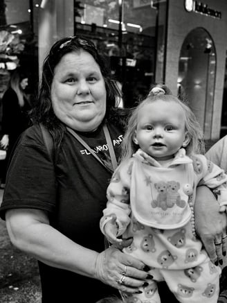 A lady with one of her adopted children - a doll! - by Peter Pickering