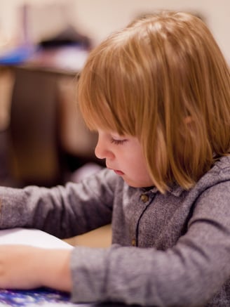 Schoolgirl sitting at her desk writing