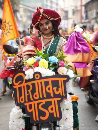 woman in maharastrian traditional outfit riding a motorbike in girgaon gudipadwa shobhayatra 2025