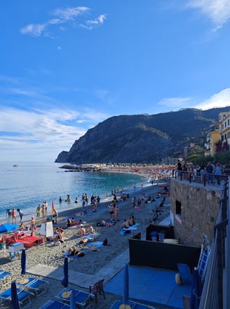 Sandy beach with lots of people in Monterosso Italy