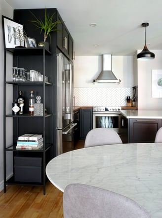 a kitchen with a marble table and chairs