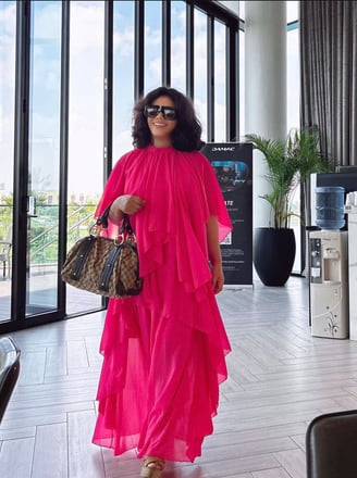 Nadia Buari in a bright pink dress.