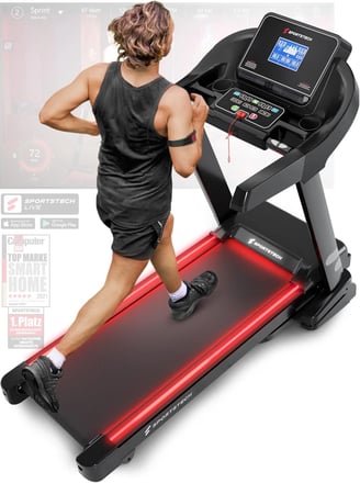 a man running on a treadmill with a red light