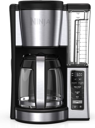 A sleek smart coffee maker brewing rich black coffee, ideal for a hassle-free morning routine.